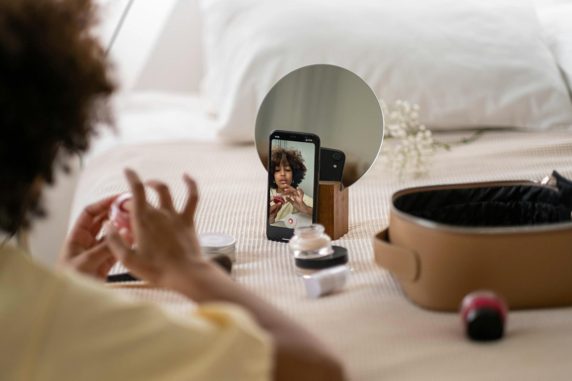 Woman Using Makeup While Doing A Recording On Phone