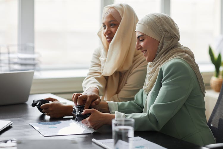 Women Playing A Video Game Together At An Office