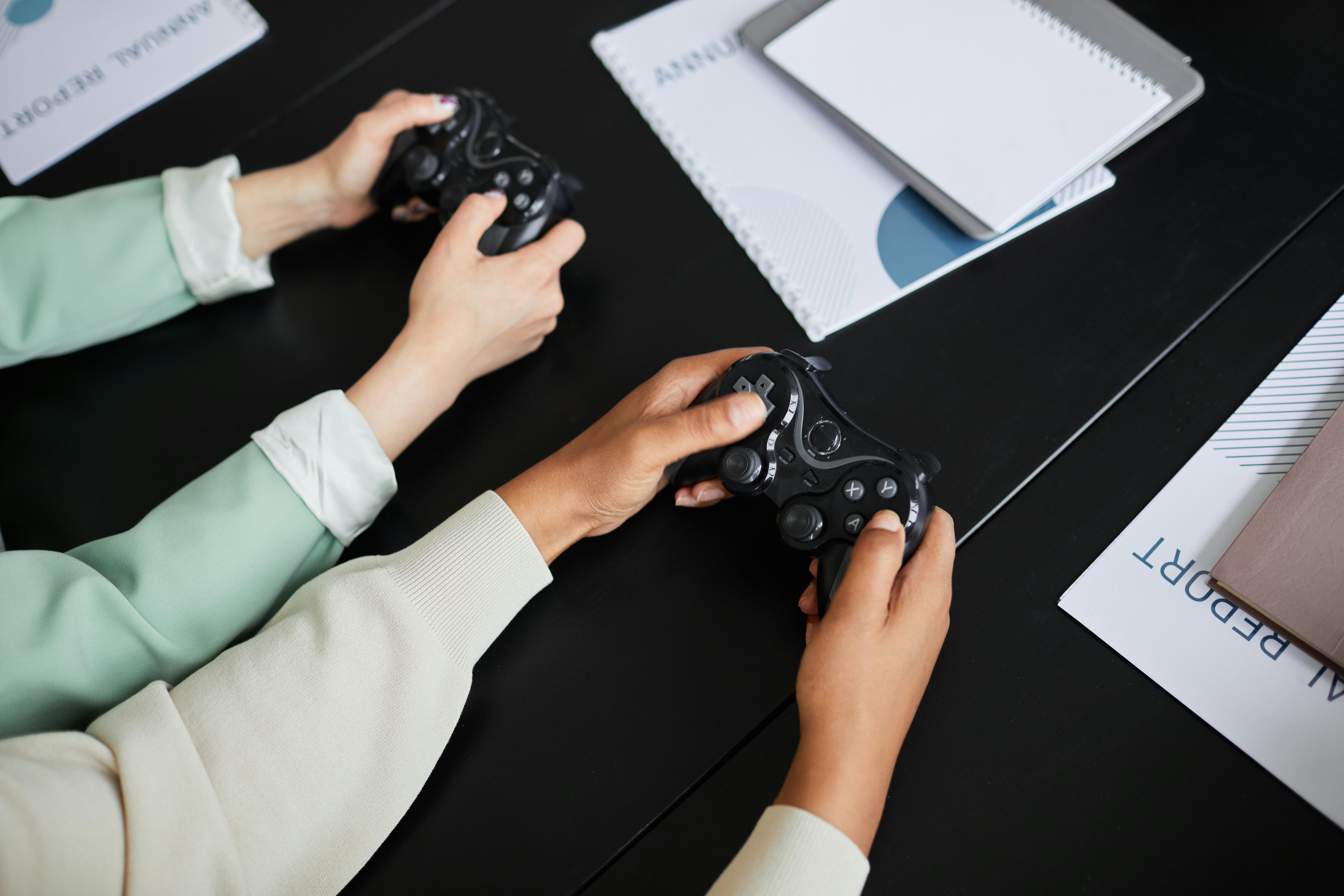 a close up shot of people using game controllers