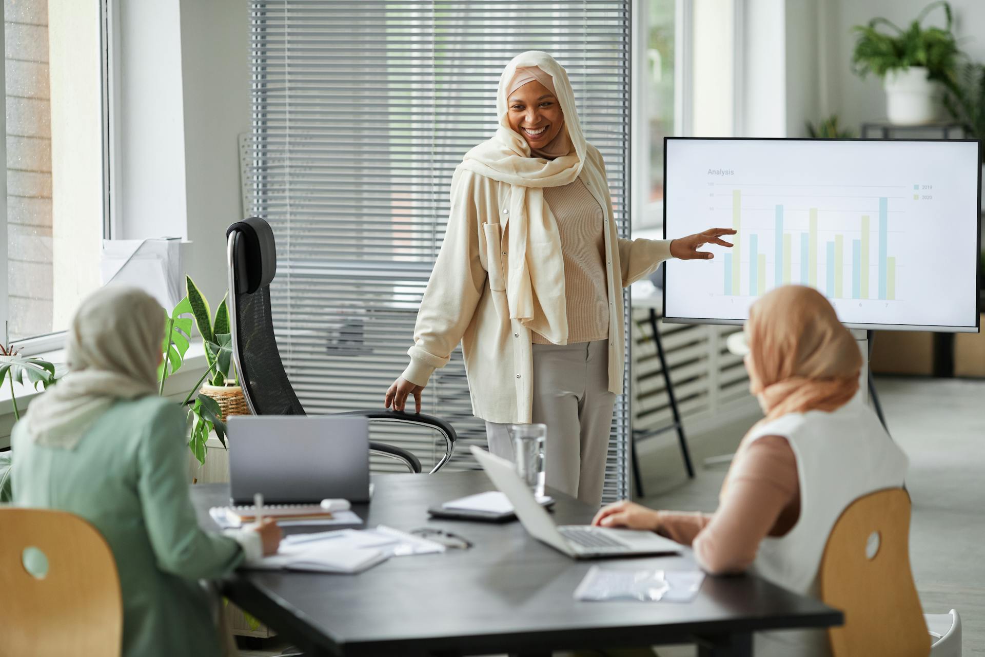 A Woman in a Business Meeting Doing a Presentation