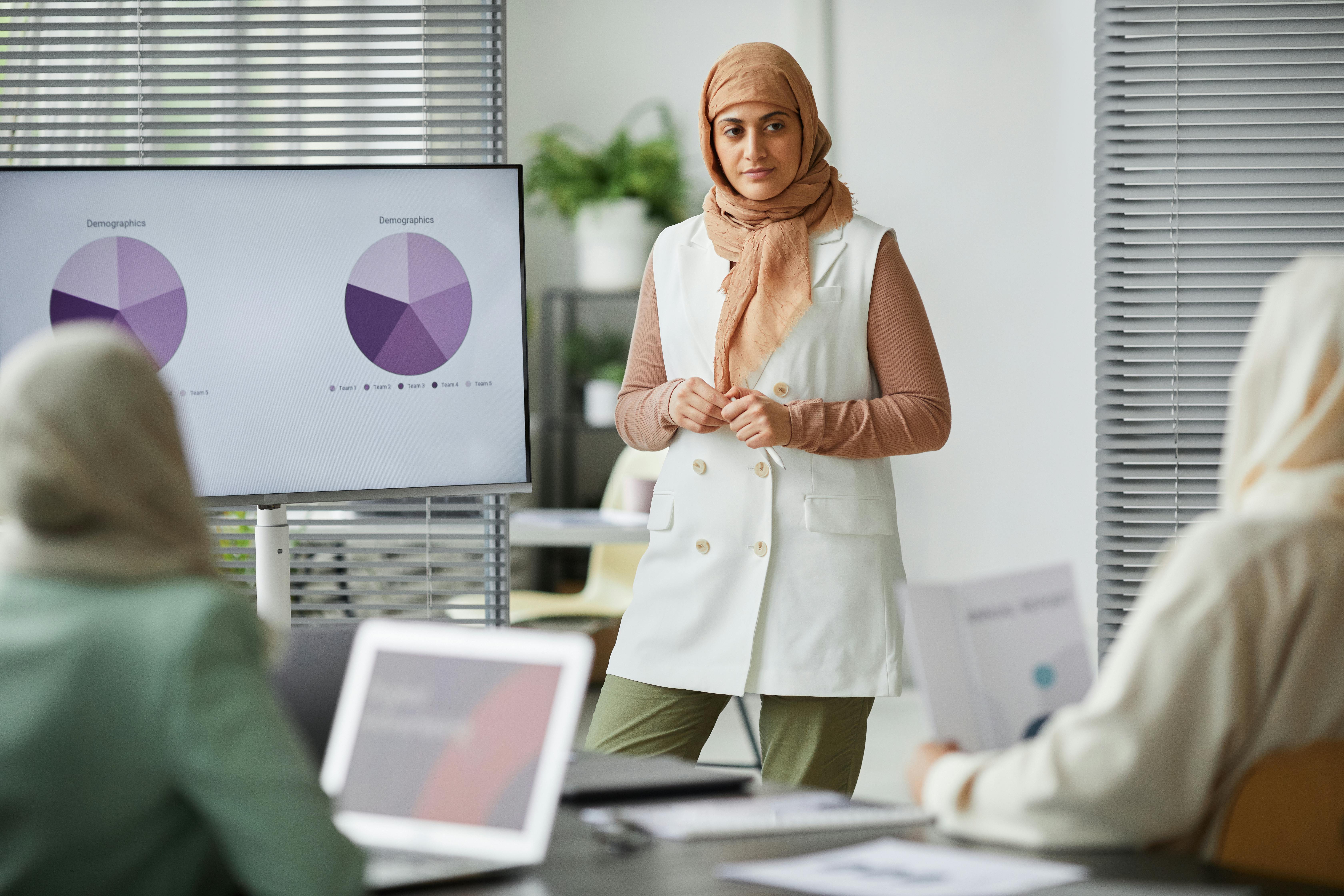 a woman standing in front of her colleagues