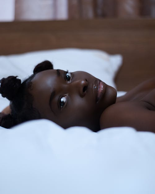 Close-up of a Young Woman Lying in Bed