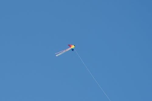 Colorful Kite on the Background of a Clear Blue Sky 