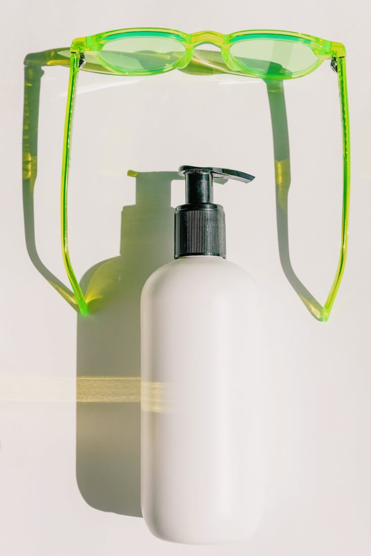 Bottle With A Pump And Green Sunglasses