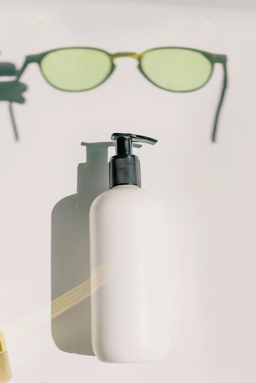 White and Black Pump Bottle of Sunscreen - How to Shave a Head with Clippers
