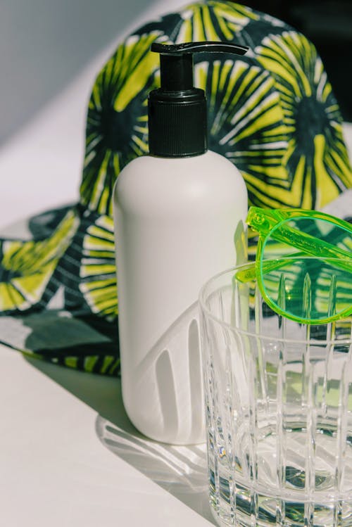 Close-up of a Pump Bottle Beside a Glass