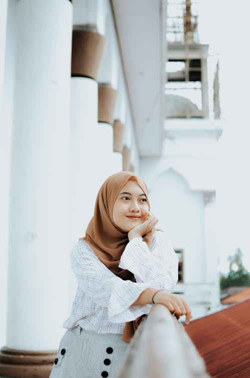 A Smiling Woman with Her Hand on Her Chin