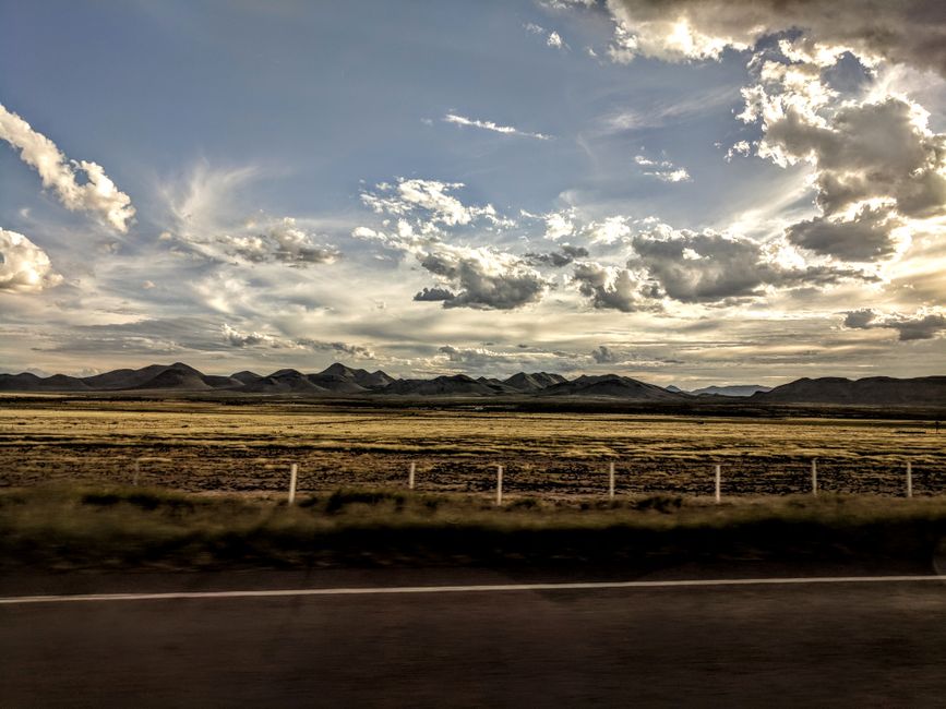 A picturesque landscape featuring clouds over rolling hills and mountains, perfect for nature enthusiasts.