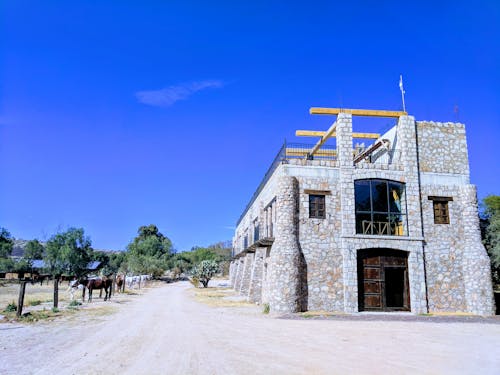Free stock photo of blue skies, horse ranch, stone building