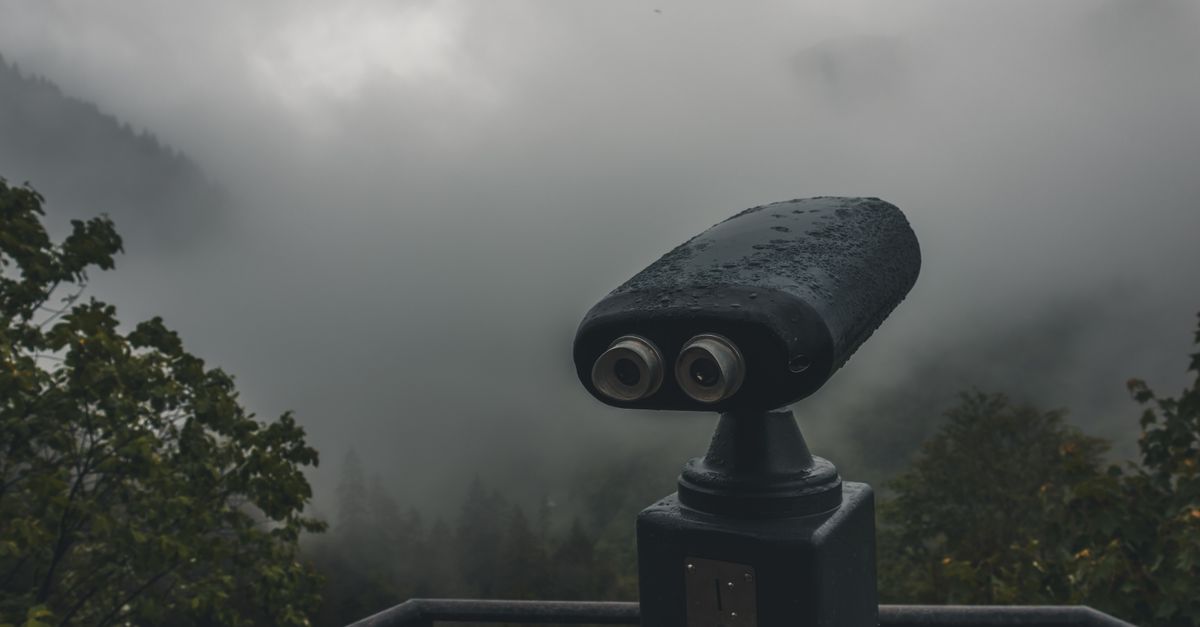 A rainy, misty view in Rize, Turkey featuring a tower viewer against a foggy landscape.