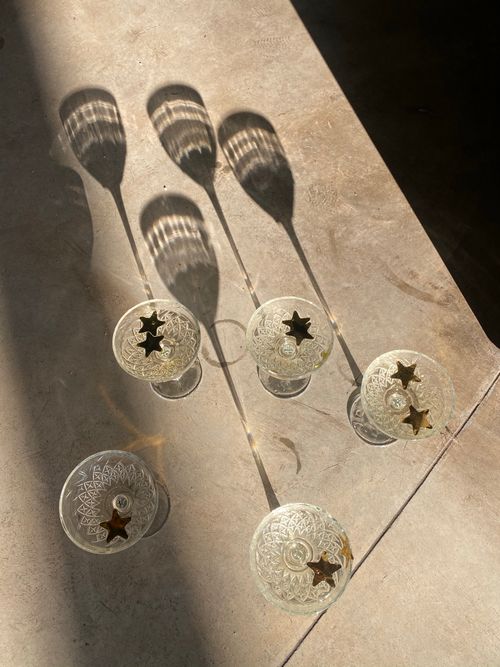 Free Intricate glassware casting star-shaped shadows under sunlight. A top view shot with a modern aesthetic. Stock Photo
