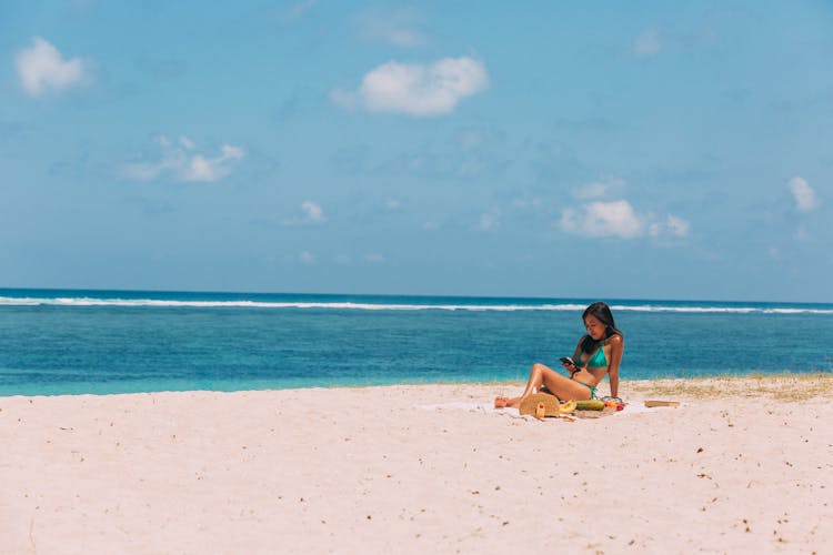 Brunette Woman Sunbathing On Beach