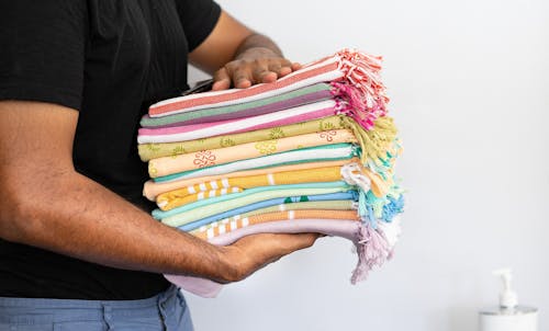 Free Ac Person Holding Folded Fabrics Stock Photo