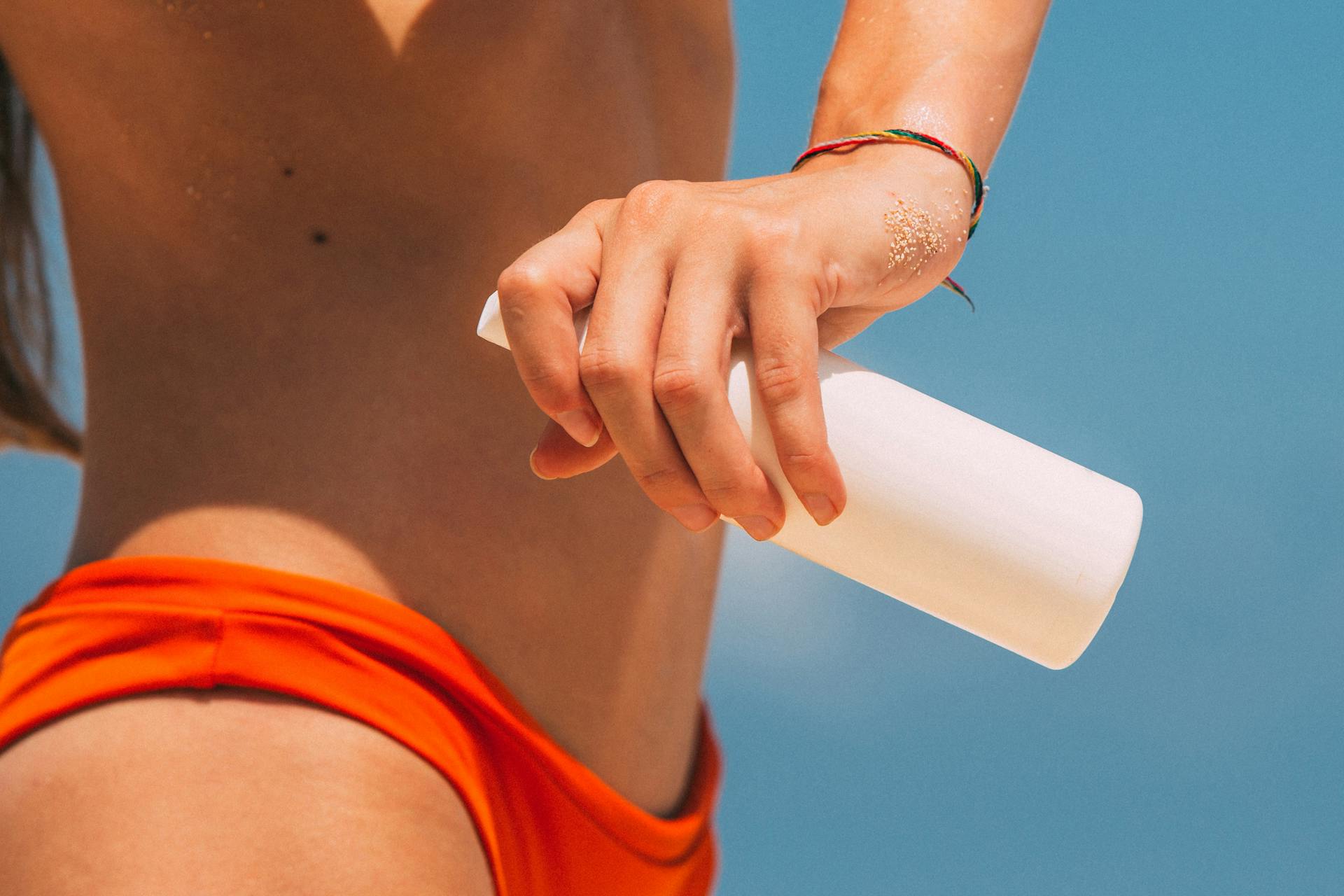 A Woman Holding a Bottle of Spray