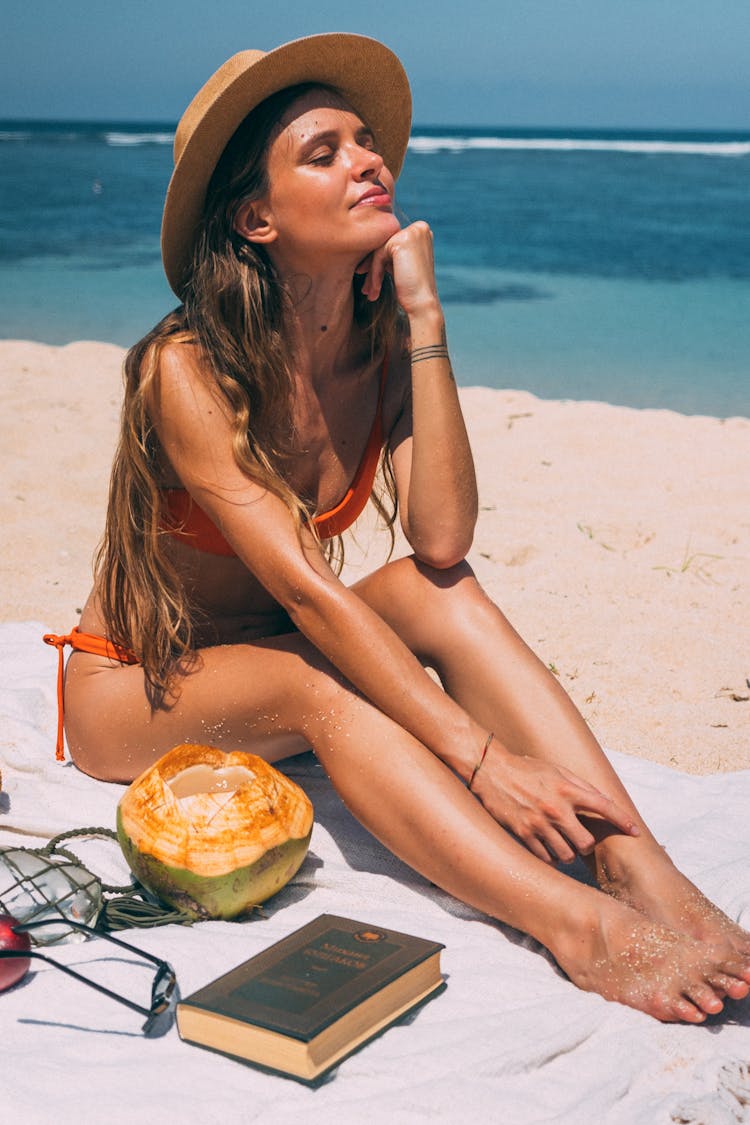 Woman Wearing A Hat At The Beach