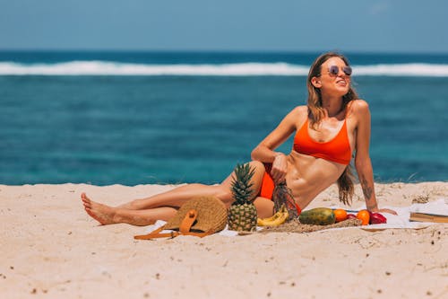 Free a Woman Relaxing on the Beach Sand Stock Photo