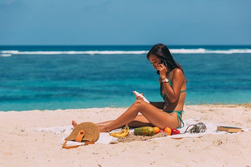 Free Woman Talking on the Phone at the Beach Stock Photo
