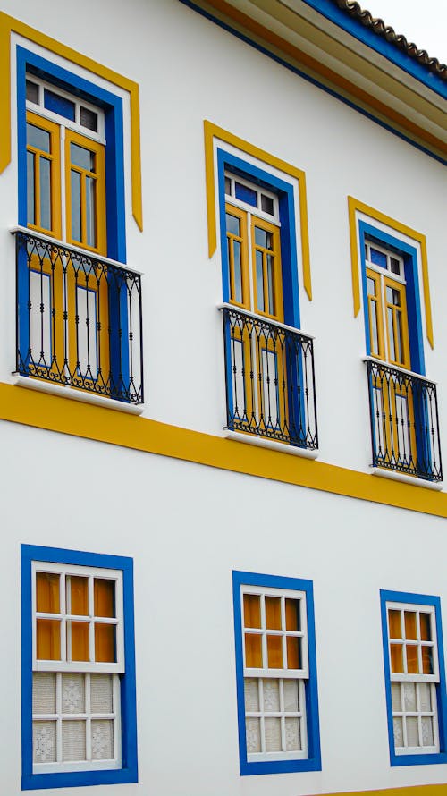 White Concrete Building with Yellow Doors and White Windows