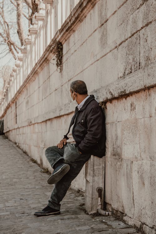 A Man Leaning on Concrete Wall