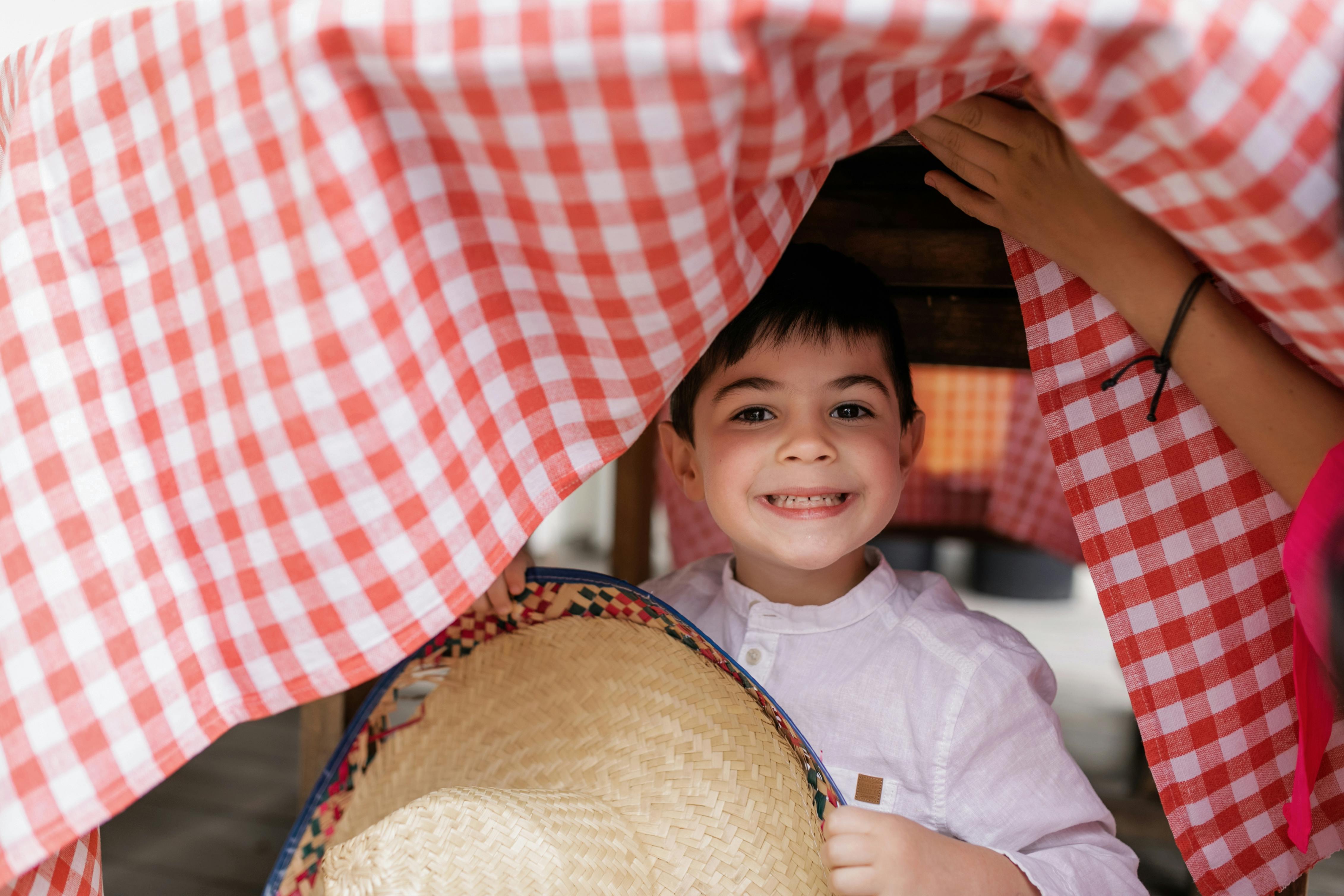 A Boy Hiding Under the Table · Free Stock Photo