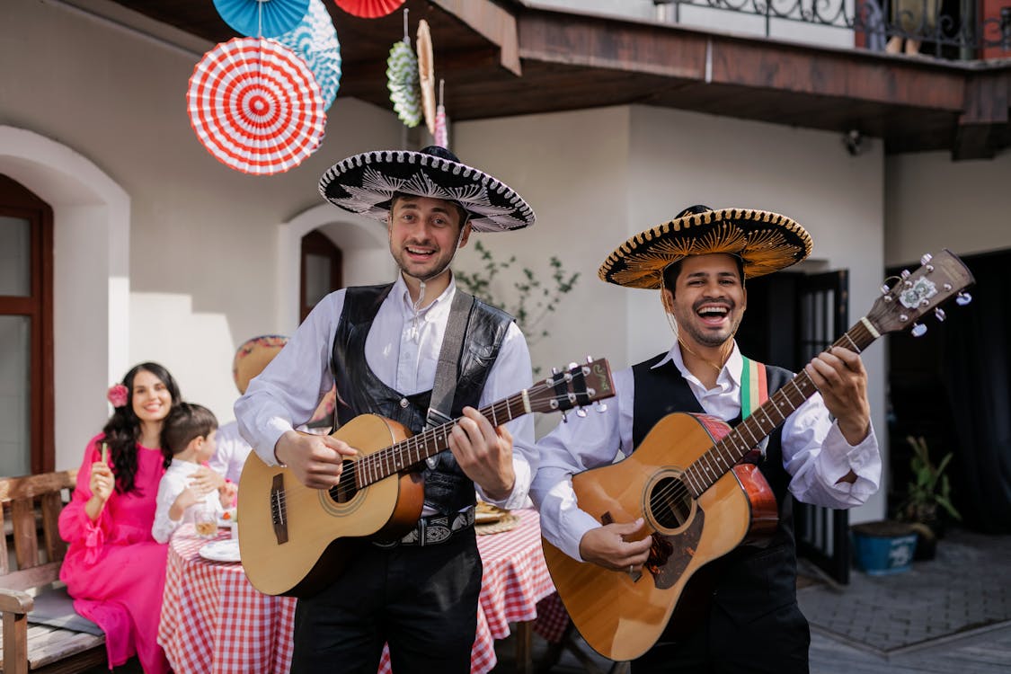 Free Men Singing and Playing Guitar in a Party Stock Photo