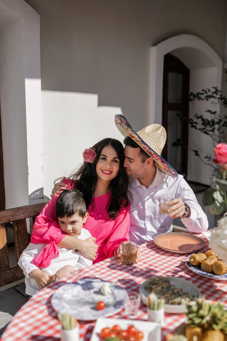 A Happy Family Sitting On The Chair