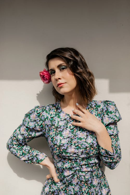 Free Beautiful Woman in  Floral Dress with Flower on Ear Stock Photo