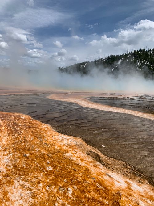 Free Vibrant geothermal landscape with steam rising at Yellowstone's Grand Prismatic Spring. Stock Photo