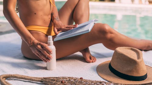 Free Close up of Woman Sitting and Reading Book at Swimming Pool Stock Photo
