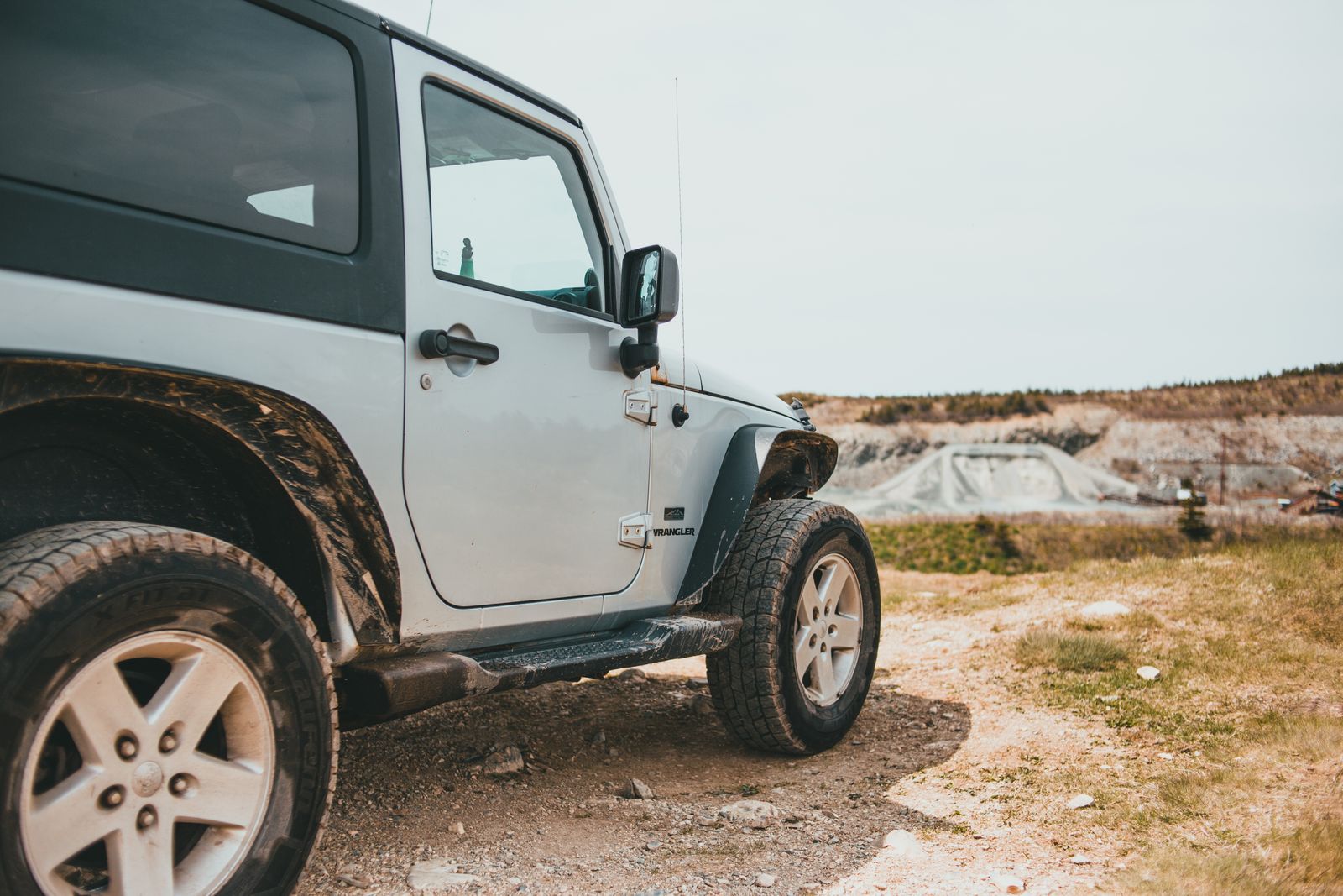 Experience the thrill of off-road driving in a rugged Jeep, set against a backdrop of wild terrain.
