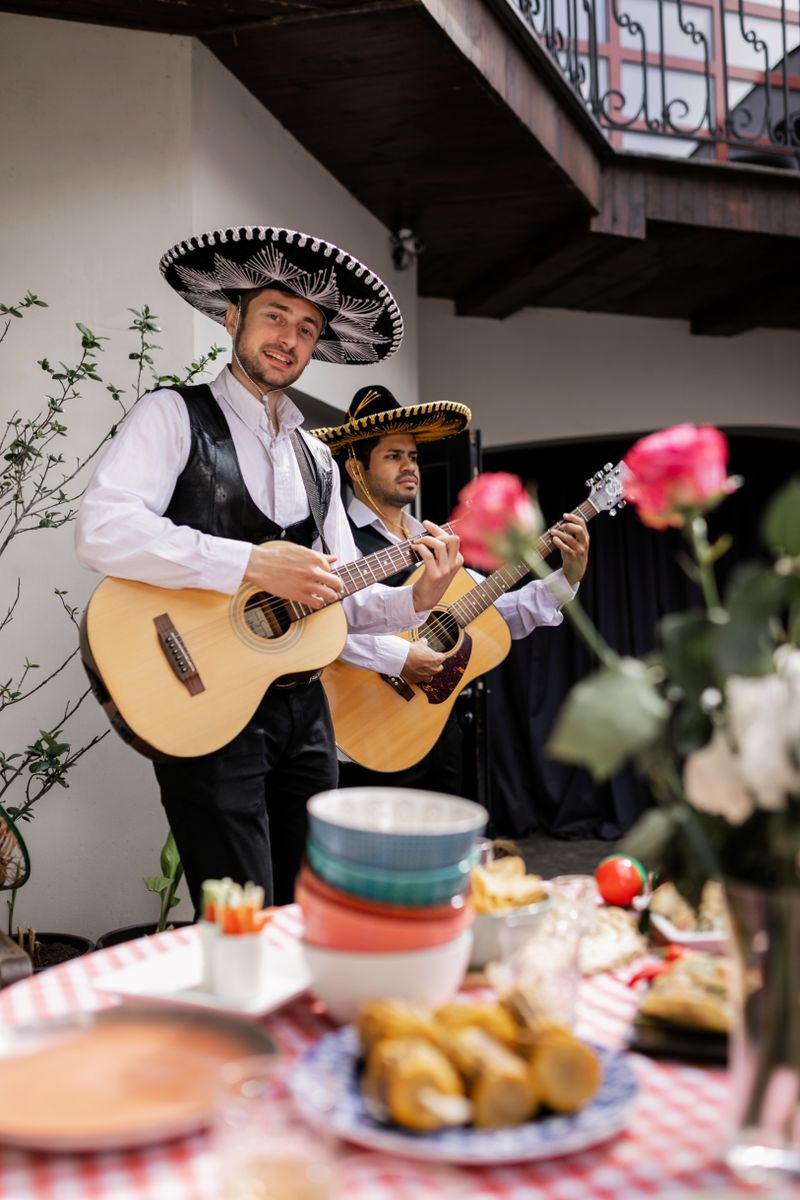 Musicians playing guitars at a lively outdoor celebration