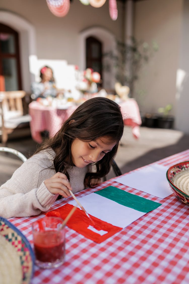 Girl Painting Mexican Flag On Table