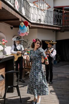 A vibrant scene capturing traditional Mexican dancing and music during a festive celebration.