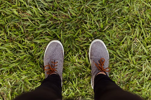 A Person in Grey Sneakers