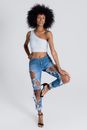 Woman in White Sports Bra and Blue Denim Shorts