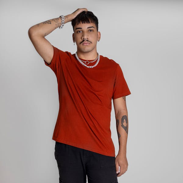 Casual portrait, man in red t-shirt, tattoos, studio shot