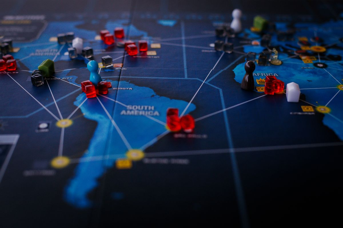 Strategic world map with playing pieces representing global capital connections