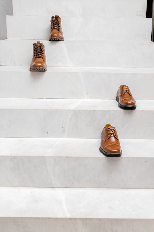 Pairs of Brown Leather Shoes on the Stairs