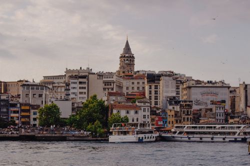 Free Scenic view of the historic Galata Tower and bustling waterfront in Istanbul, Turkey. Stock Photo