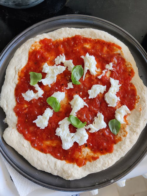 Pizza With Green Leaves on Ceramic Plate