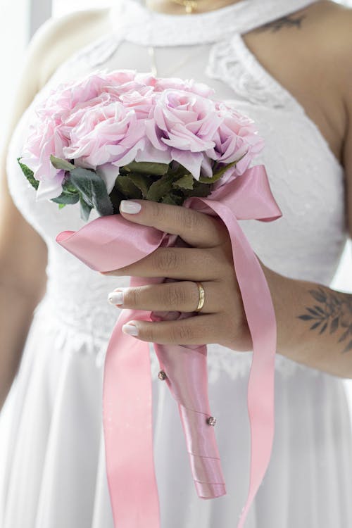 Woman in White Dress Holding a Wedding Bouquet
