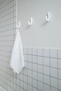 White Towel on White Tiled Bathroom