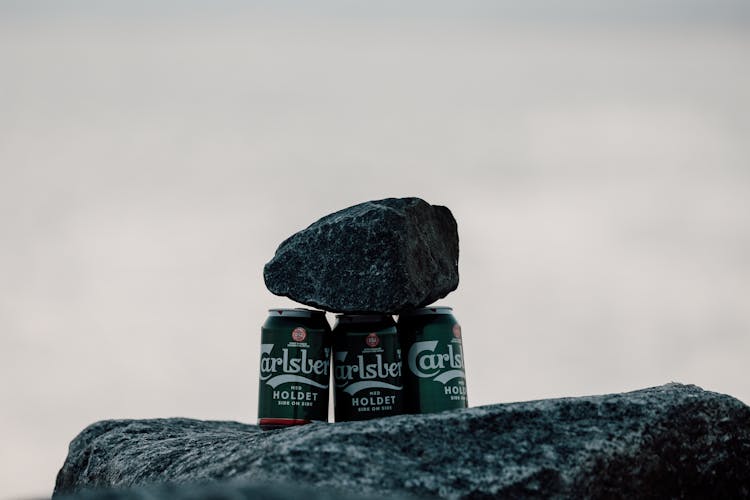 A Rock On Cans Of Beer