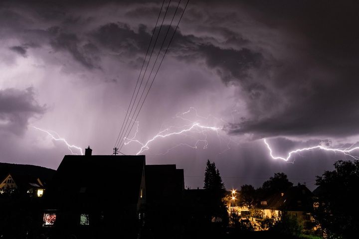 Whole home surge protection in Orem Lightning storm over a house at night, a common cause of power surges