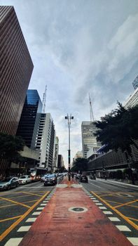 Vertical view of Paulista Avenue bustling with traffic, surrounded by skyscrapers in São Paulo, Brazil.