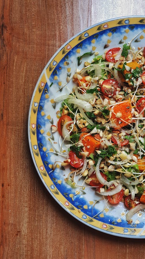 A Plate of Vegetables Salad on a Wooden Surface