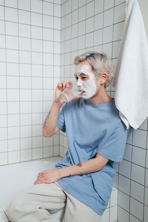 Free Man in Blue Crew Neck T-shirt Drinking Water  Stock Photo