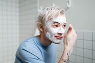 Man in Blue Crew Neck Shirt With White Cream On Face