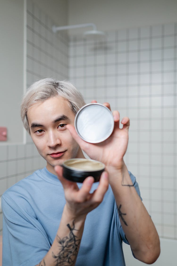 Young Man Holding A Hair Product