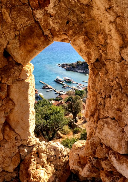 Free A picturesque view of a marina through an ancient rock arch in Antalya, Turkey. Stock Photo